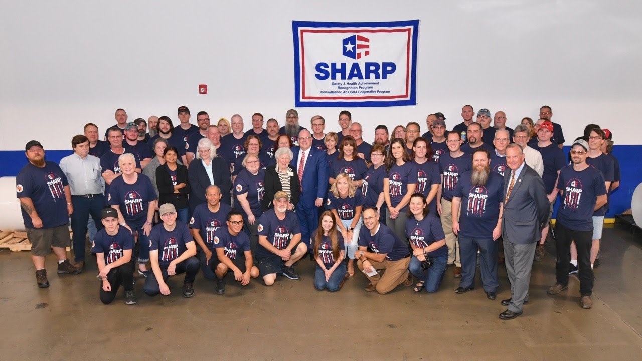 Team photo with Governor Hogan in front of SHARP banner