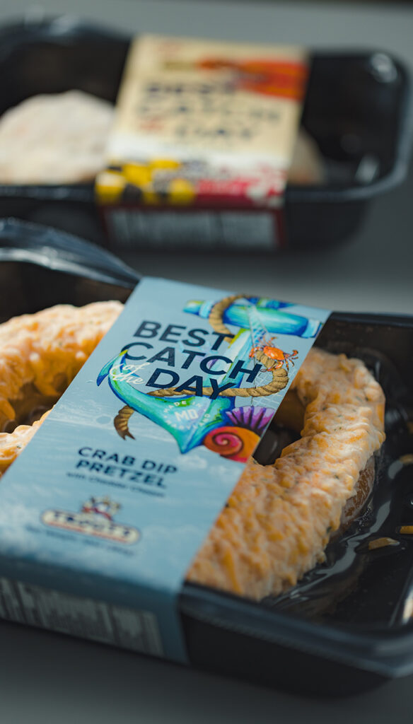 Linerless label wrapped around a crab dip pretzel. Linerless labels are commonly used for cryovac wrapped seafood products.