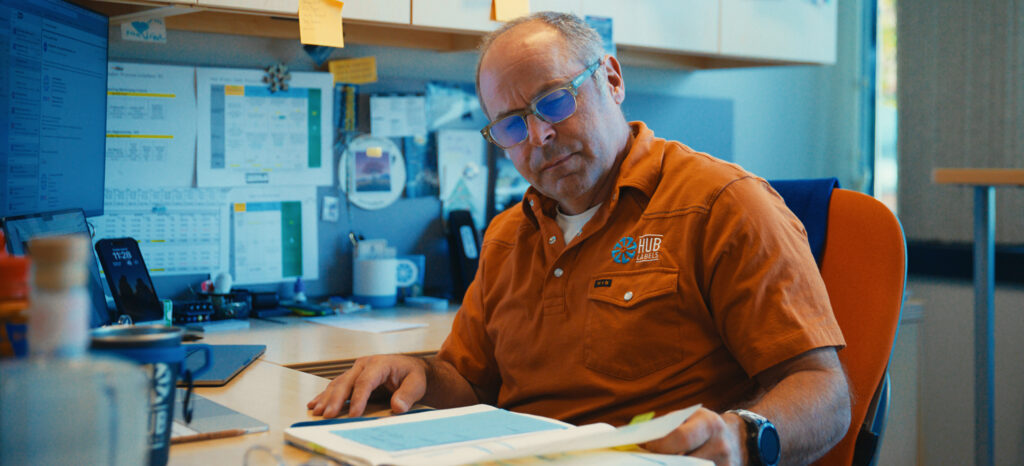 Family-owned label manufacturing company employee working on custom label tasks.
